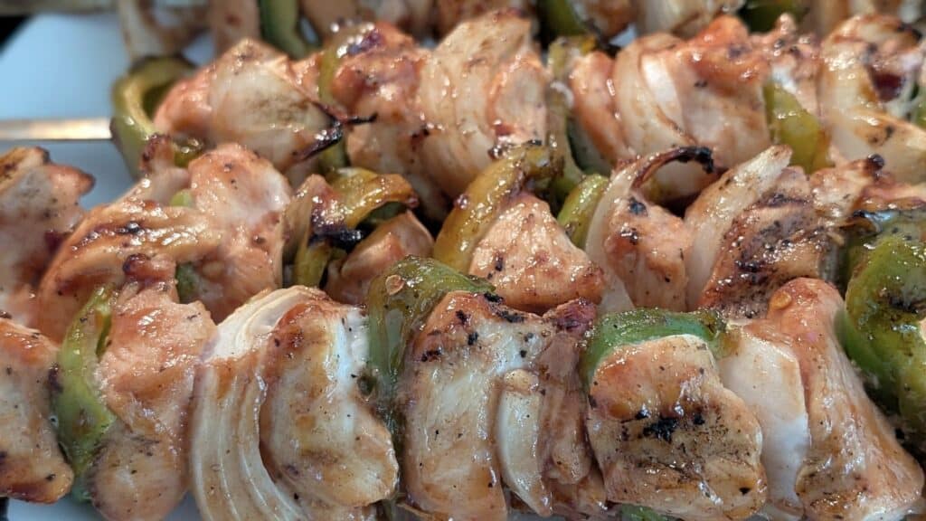 Grilled chicken and bell peppers skewers, perfectly cooked with charred edges and tender meat, ideal for summer barbecues and outdoor meals.