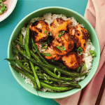 Succulent meatball bowl with rice and green beans, healthy meal with flavorful sauce, vibrant food image for comfort food and dinner ideas, served in a pastel green bowl.
